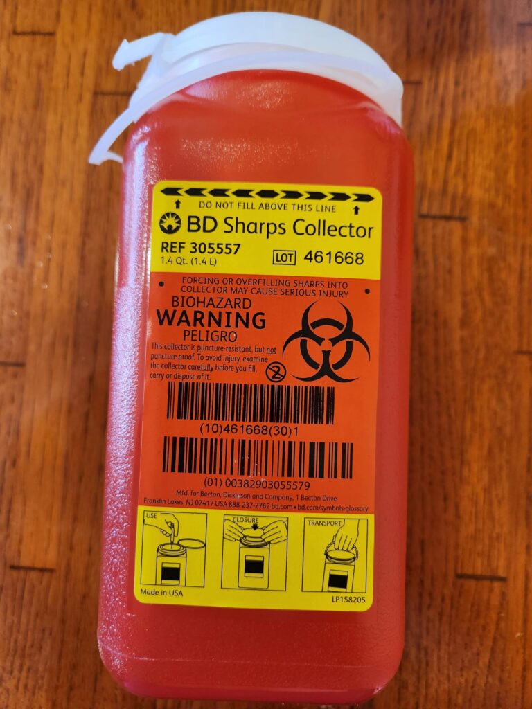 red sharps disposal container